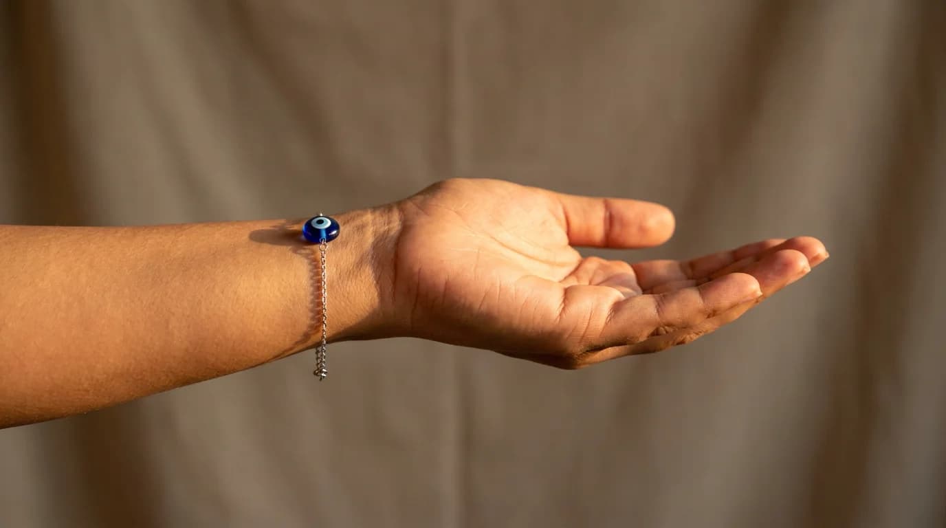 Evil eye bracelet worn on left wrist in natural light showing nazar kavach charm position